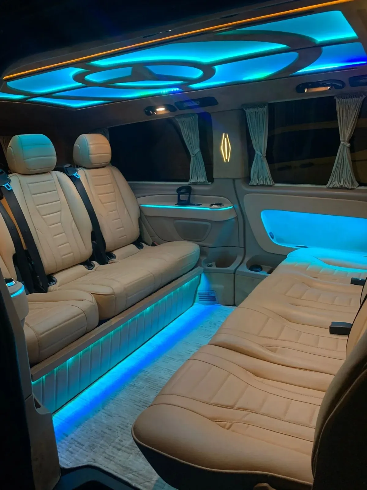 Cream leather seats and ambient lighting inside the transfer minivan